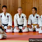 Home 16 유도 벨트 단계별 설명 - **A Beginner's First Step: The White Belt Ceremony**
A young adult, perhaps in their late teens ...